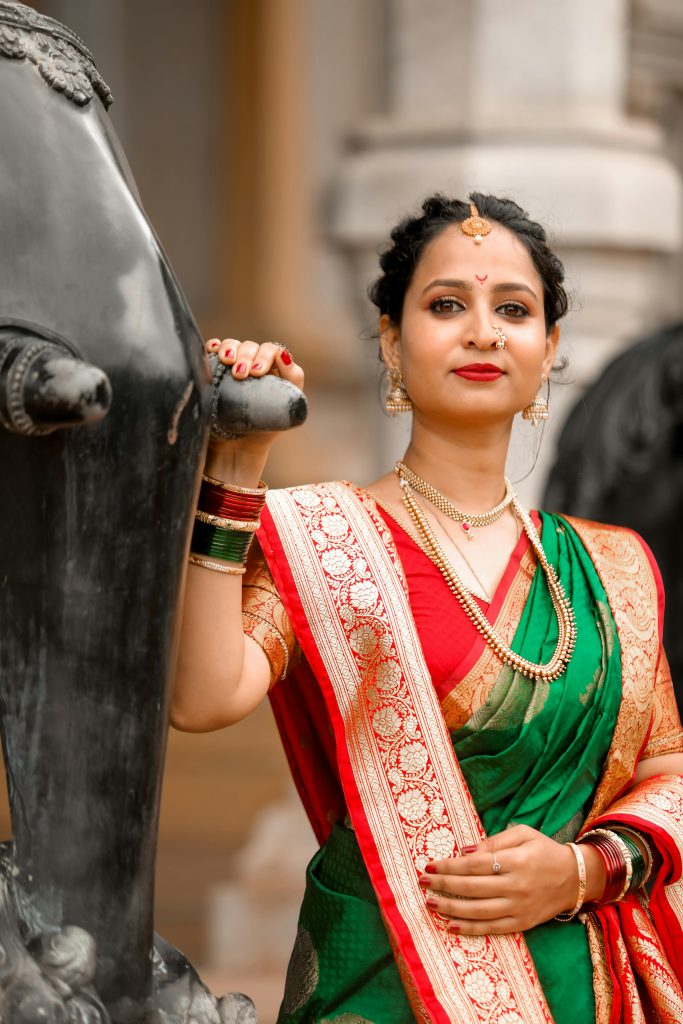 Elegant Indian woman posing in a vibrant traditional saree, exemplifying cultural heritage.