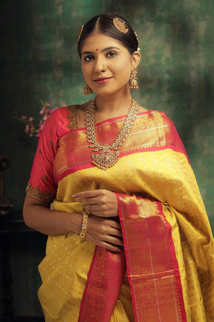 Elegant Indian woman in saree adorned with traditional gold jewelry